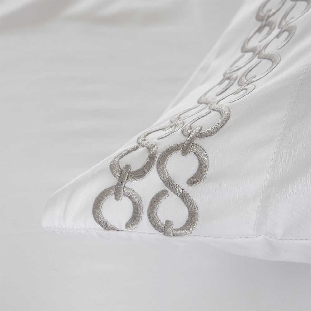 Juego de sábanas blanco de satén algodón 400 hilos con delicado bordado decorativo, acabado elegante y tacto excepcionalmente suave.