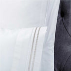 Sábana encimera blanca bordada en percal de algodón 200 hilos, ideal para un dormitorio elegante y luminoso.